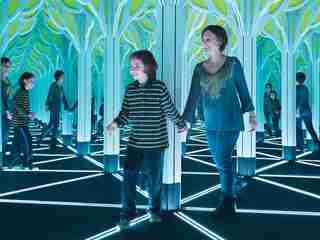 A child and parent go through the Numbers in Nature Mirror Maze