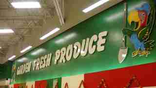 The produce section of a grocery store, under signage reading "Garden Fresh Produce."