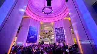 The Museum Rotunda filled with seated and mingling guests at the 2024 Black Creativity Gala